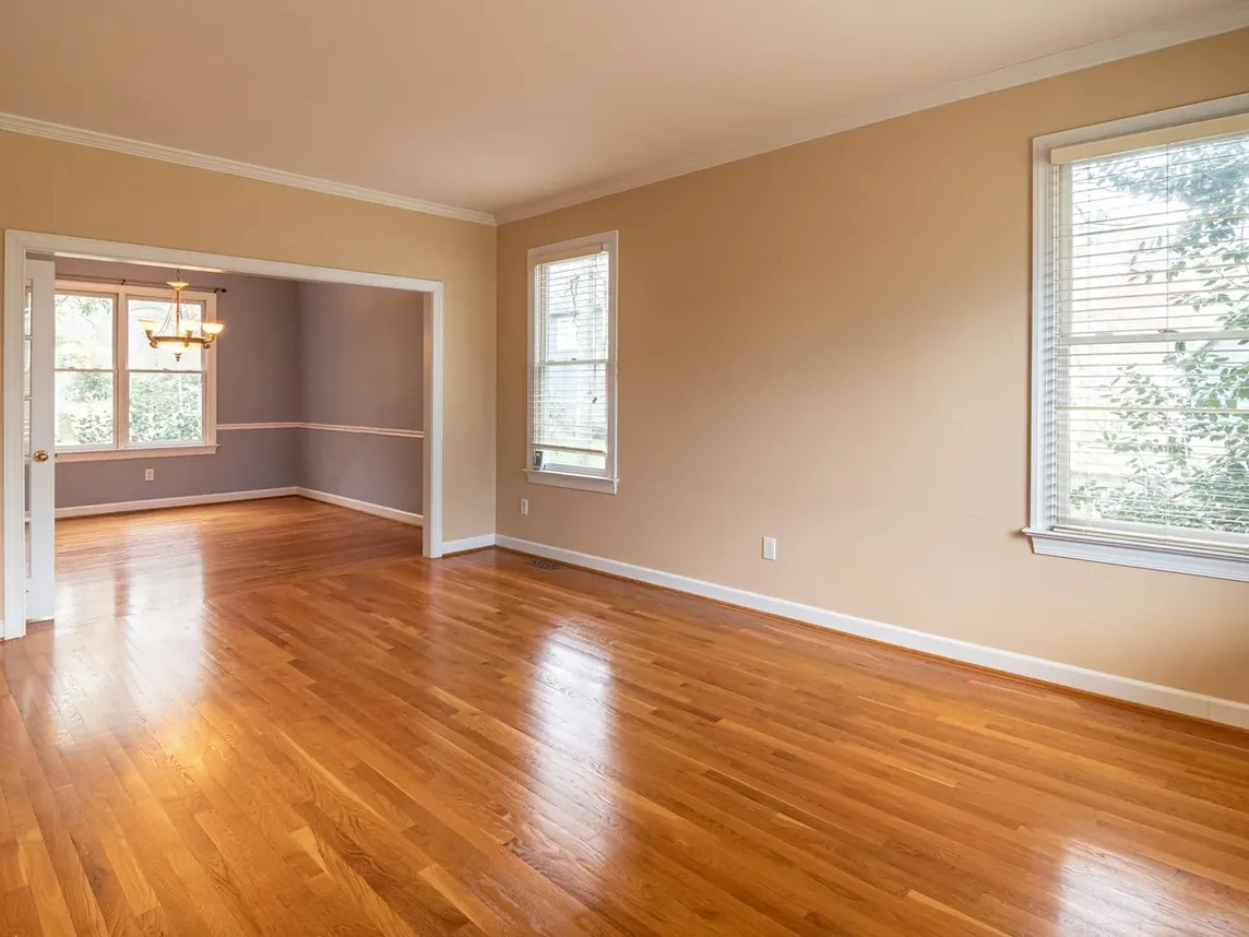 An emptied room with bare wooden floors after a full house clearance