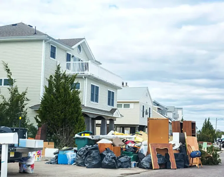 Bagged contents and furniture at the curb outside multi-family homes